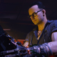 A screenshot from Cyberpunk 2077 depicting cybernetic doctor Vicktor staring at a monitor of some kind.
